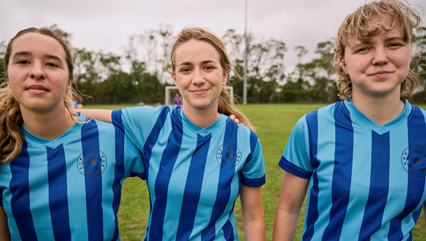 A group of community soccer players (a local team) are standing together.