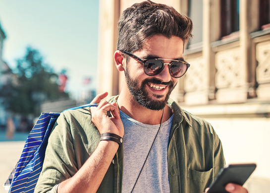 Man travelling checking phone.