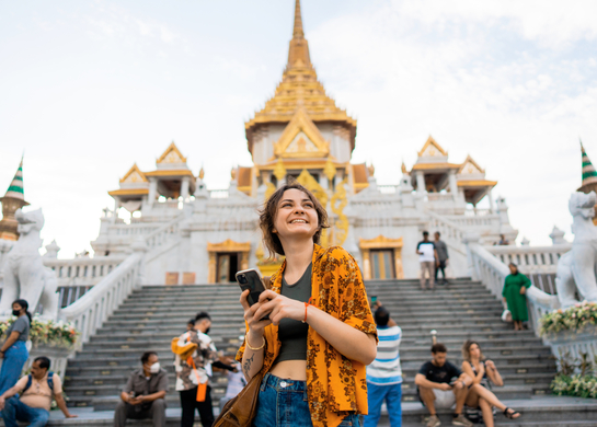 Woman at temple travelling and smiling.