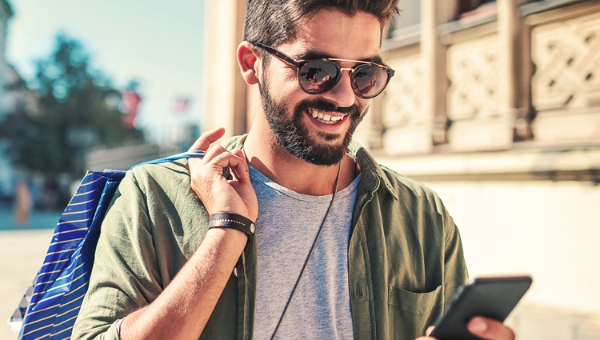 Man travelling checking phone.