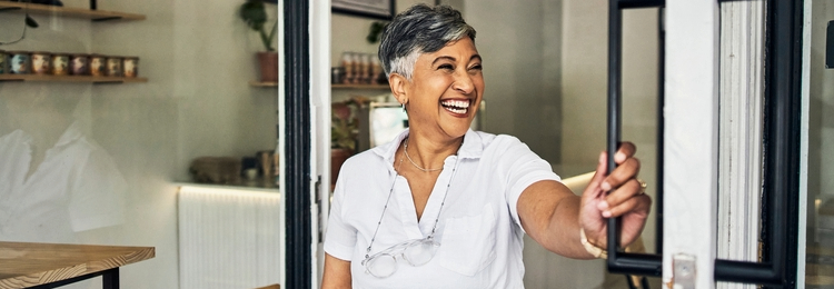 Woman opening up cafe at start of day