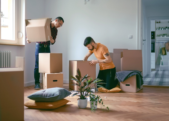 Couple unpacking boxes in new home.