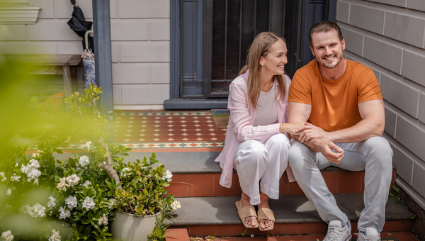 Couple on porch of home.