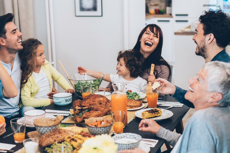 Family and grandparents enjoying lunch together.
