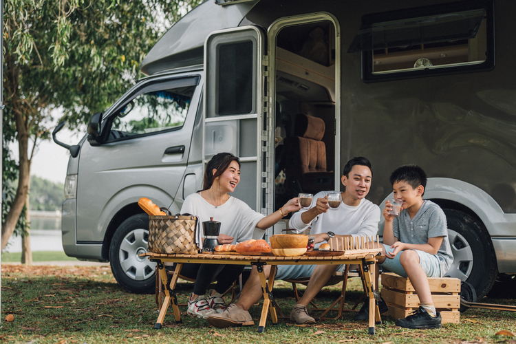 Family with motor home camping out.