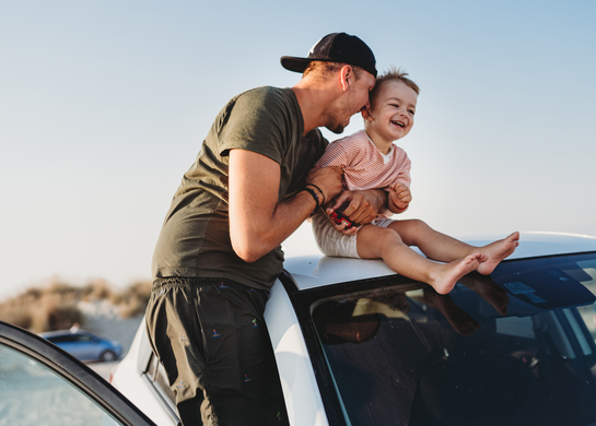 Dad drives his son to the beach