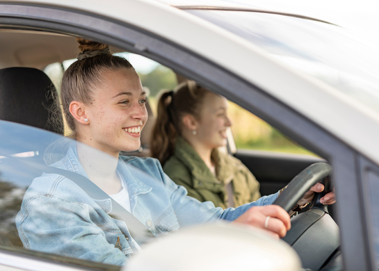 Young woman driving her friends around