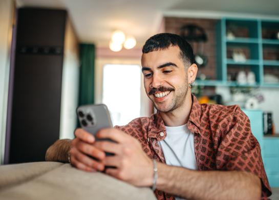 man smiling at phone
