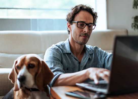 man working beside dog