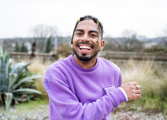 Smiling man with a purple sweater