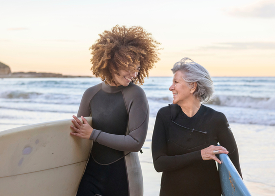 Women holding surf boards