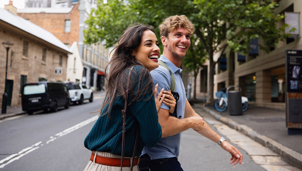 couple laughing crossing road