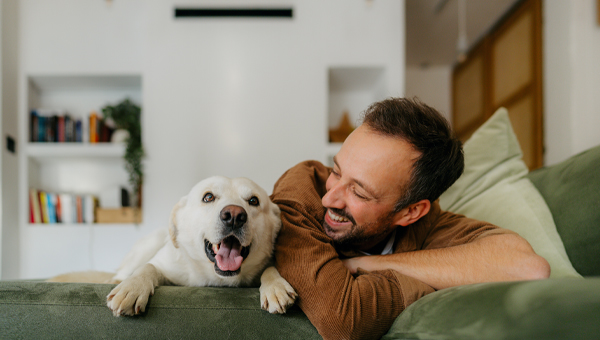 man relaxing on couch withdog