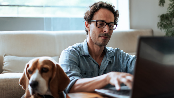 man working beside dog