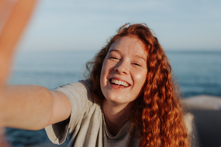 Woman with red hair takes a selfie