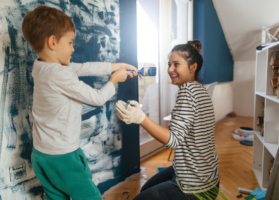 Mom and son paint a bedroom
