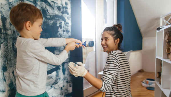 Mom and son paint a bedroom