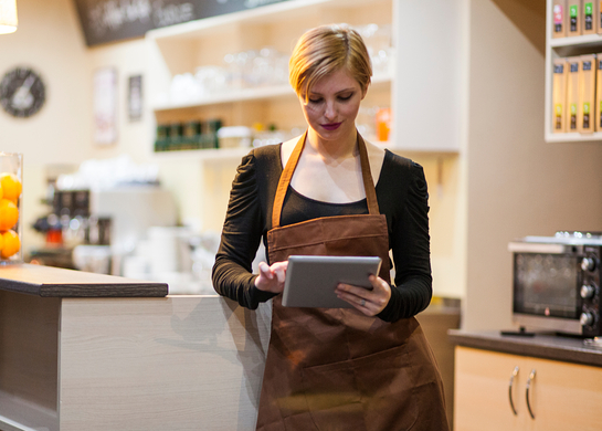 Cafe owner uses a tablet