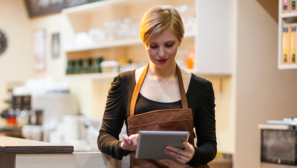 Cafe owner uses a tablet