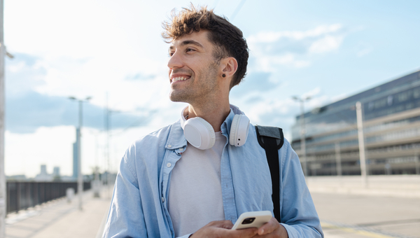 Man smiles while he is walking