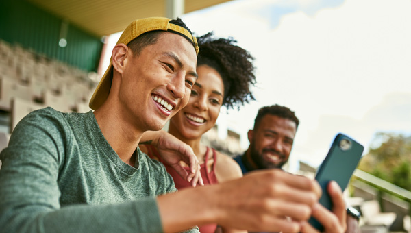 People look at a phone in the grandstand.
