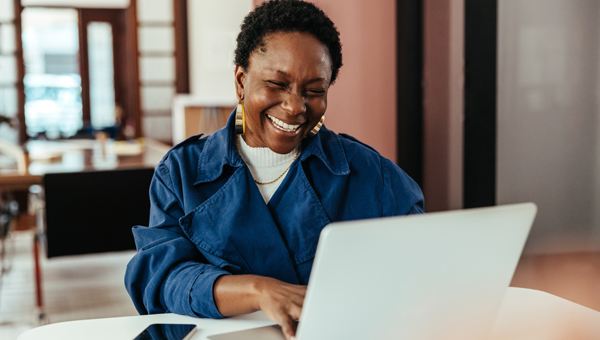 woman on laptop laughing