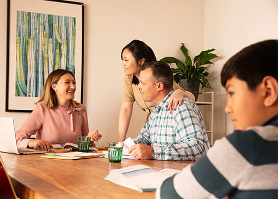 Parents with financial planner at dining table