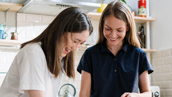 Young women kitchen smiling