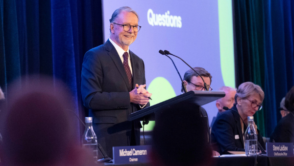 People First Bank Chairman Michael Cameron standing at a podium during question period at our Annual General Meeting.